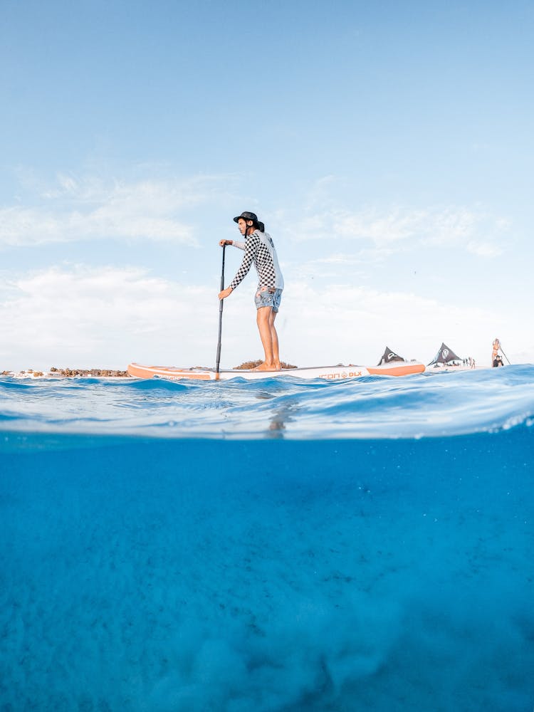 Picture Taken Half Underwater Of A Man On A Paddle Board