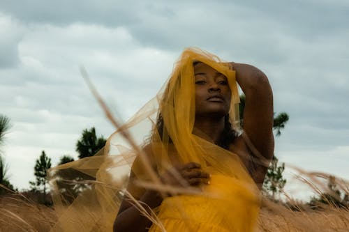 Woman Posing under Yellow Veil