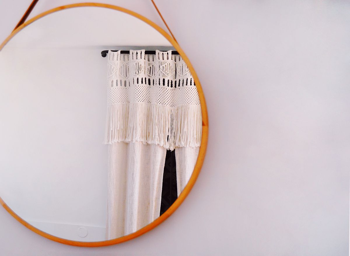 Round wood-framed wall mirror, the kind of large mirror that needs padding and a mirror box for moving