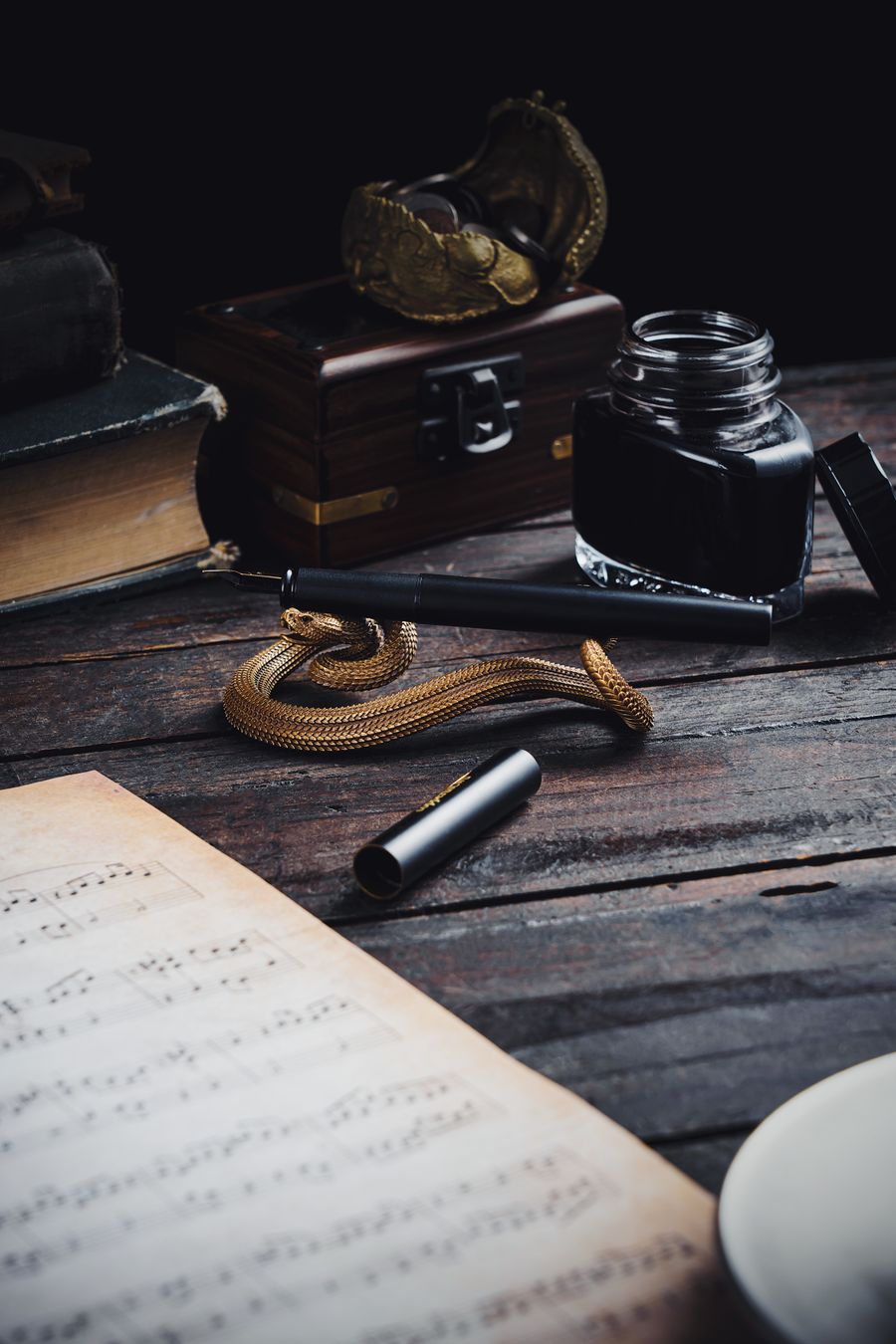 Quill pen, ink and antique books — the craft of authorship