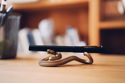 Close-up of a sleek pen resting on a snake-shaped holder, ideal for elegant stationery decor.