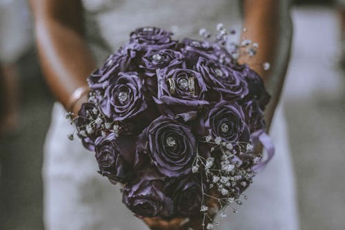 Bride Holding Bouquet of Purple Flowers