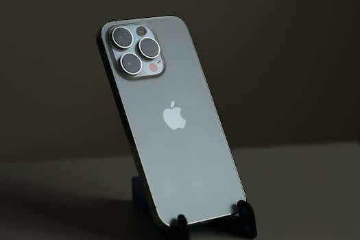 Close-up of a sleek smartphone on a holder with a neutral background, highlighting design.
