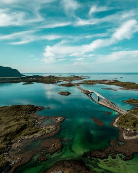 Captivating aerial shot of the Vestvågøy bridge and scenic landscape in Nordland, Norway.