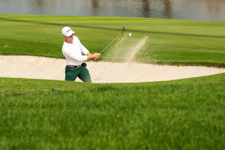 Man Hitting The Ball With A Club In Golf 