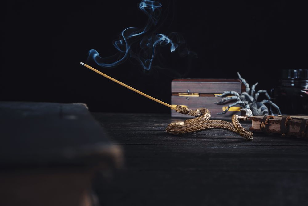 Incense smoke curling over a dark museum table — photo by COPPERTIST WU on Pexels
