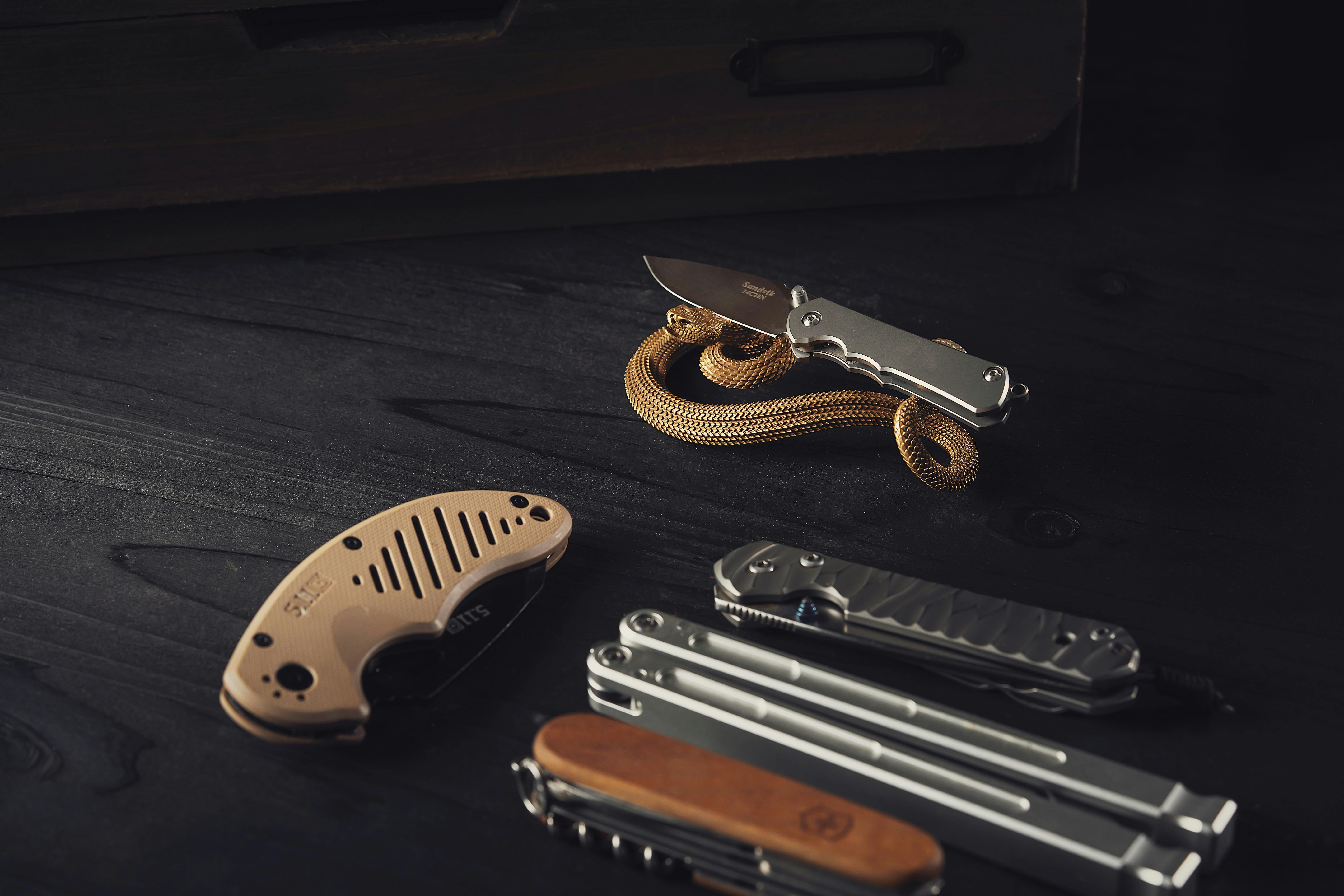 Close-up of Sharp Tools Lying on Dark Wooden Surface · Free Stock Photo