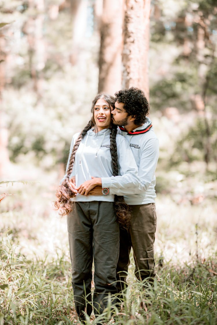 Couple Hugging And Kissing In Nature