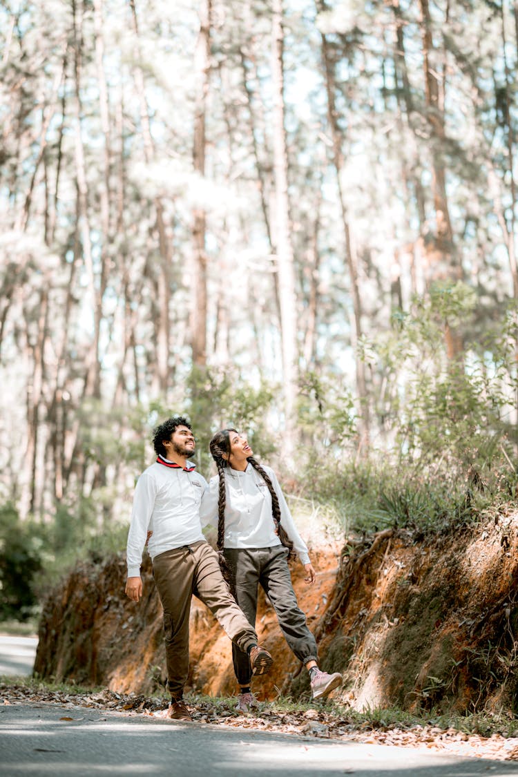 Couple Happily Walking In Forest