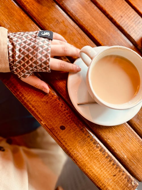 Woman Hand on Table with Coffee