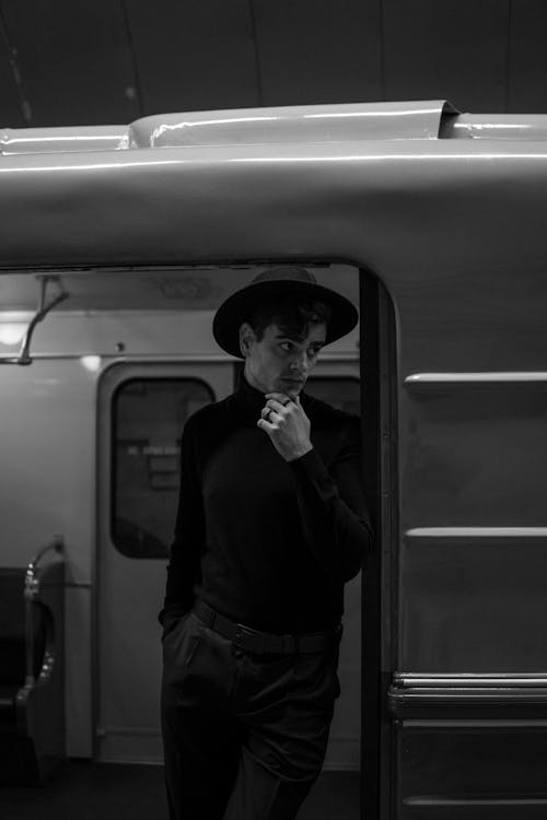 Man in Hat Posing in Metro Door