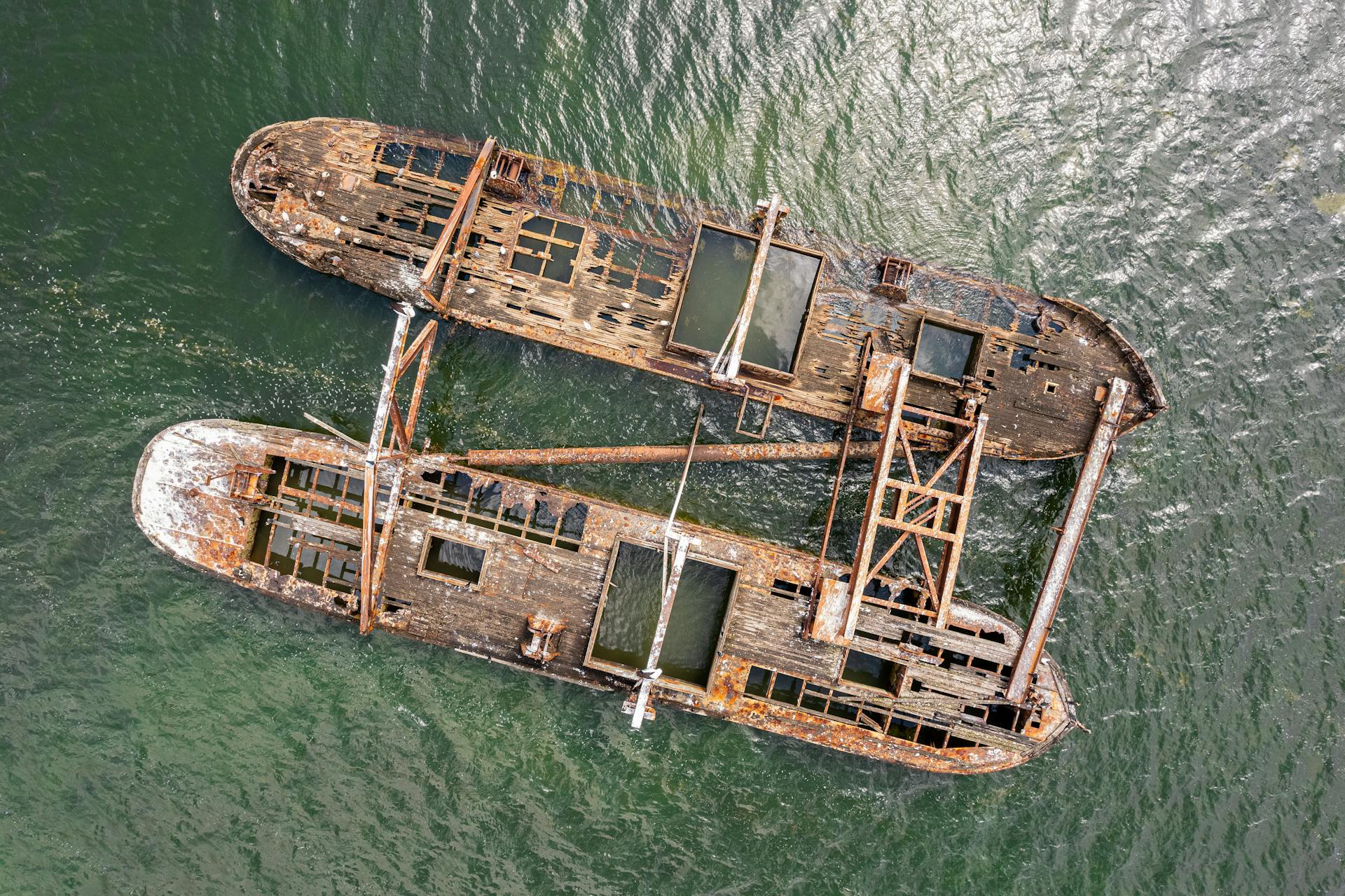 Drone shot of a rusty shipwreck in Hastings, Australia showing the dramatic decay and textures.