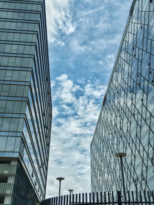 Free Contemporary glass buildings against a vivid sky, showcasing urban architecture. Stock Photo