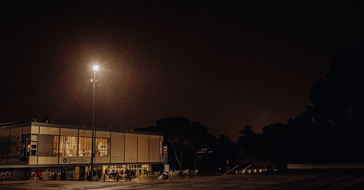 night view of Christ Embassy Loveworld Arena lit up with worshipers exiting after service