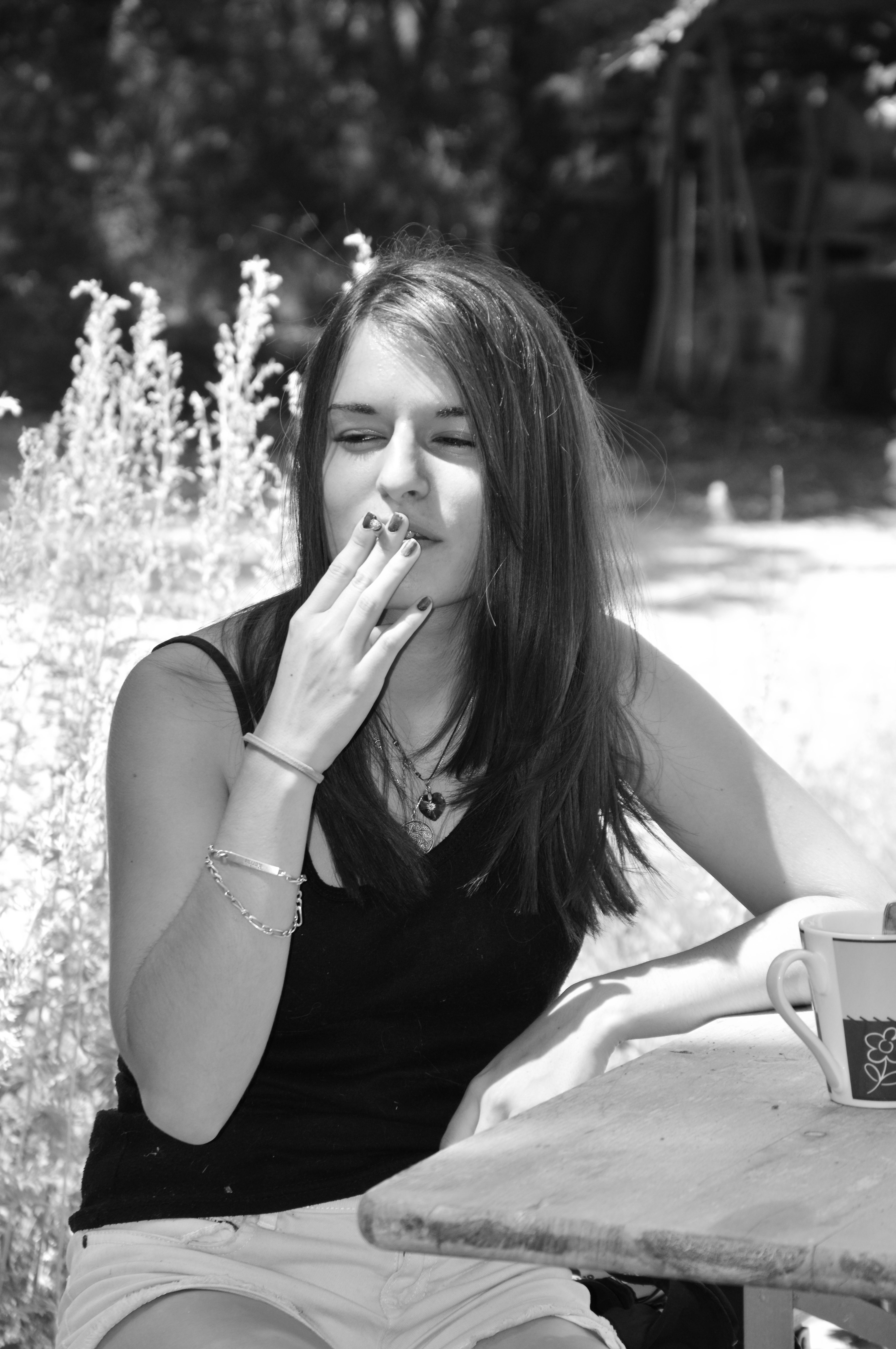 Woman Sitting On Wall And Smoking Free Stock Photo
