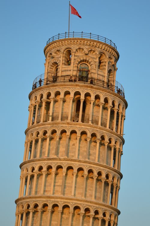 Free Close-up view of the iconic Leaning Tower of Pisa against a blue sky at sunset. Stock Photo