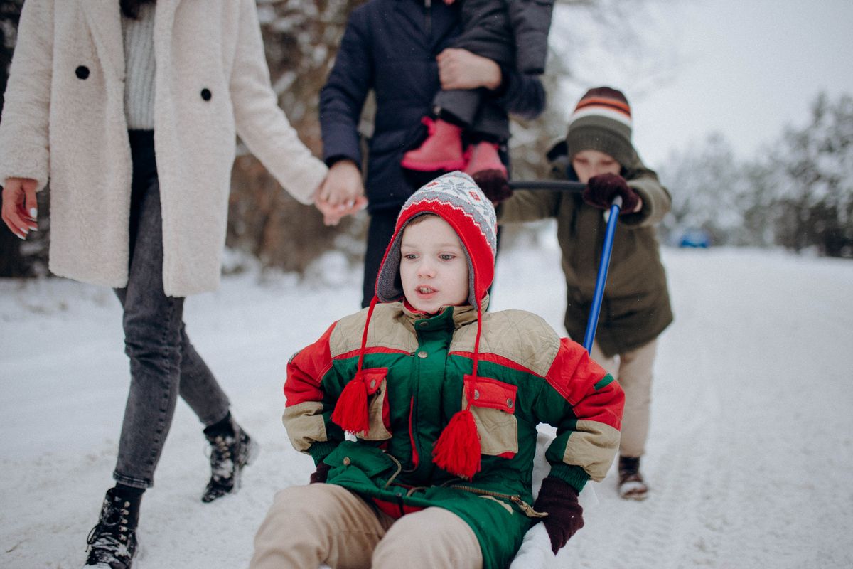 Kid on sled in snow