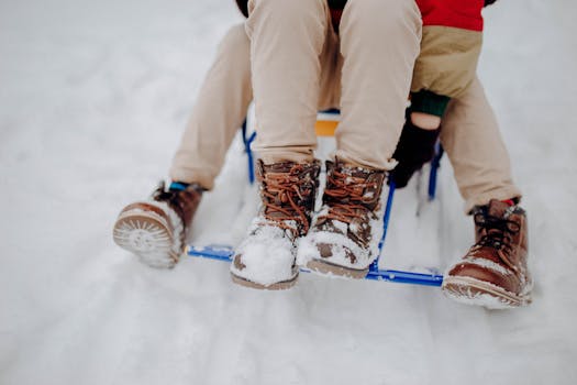 Children in winter clothing having fun on a sled ride in the snow, highlighting joy and togetherness.