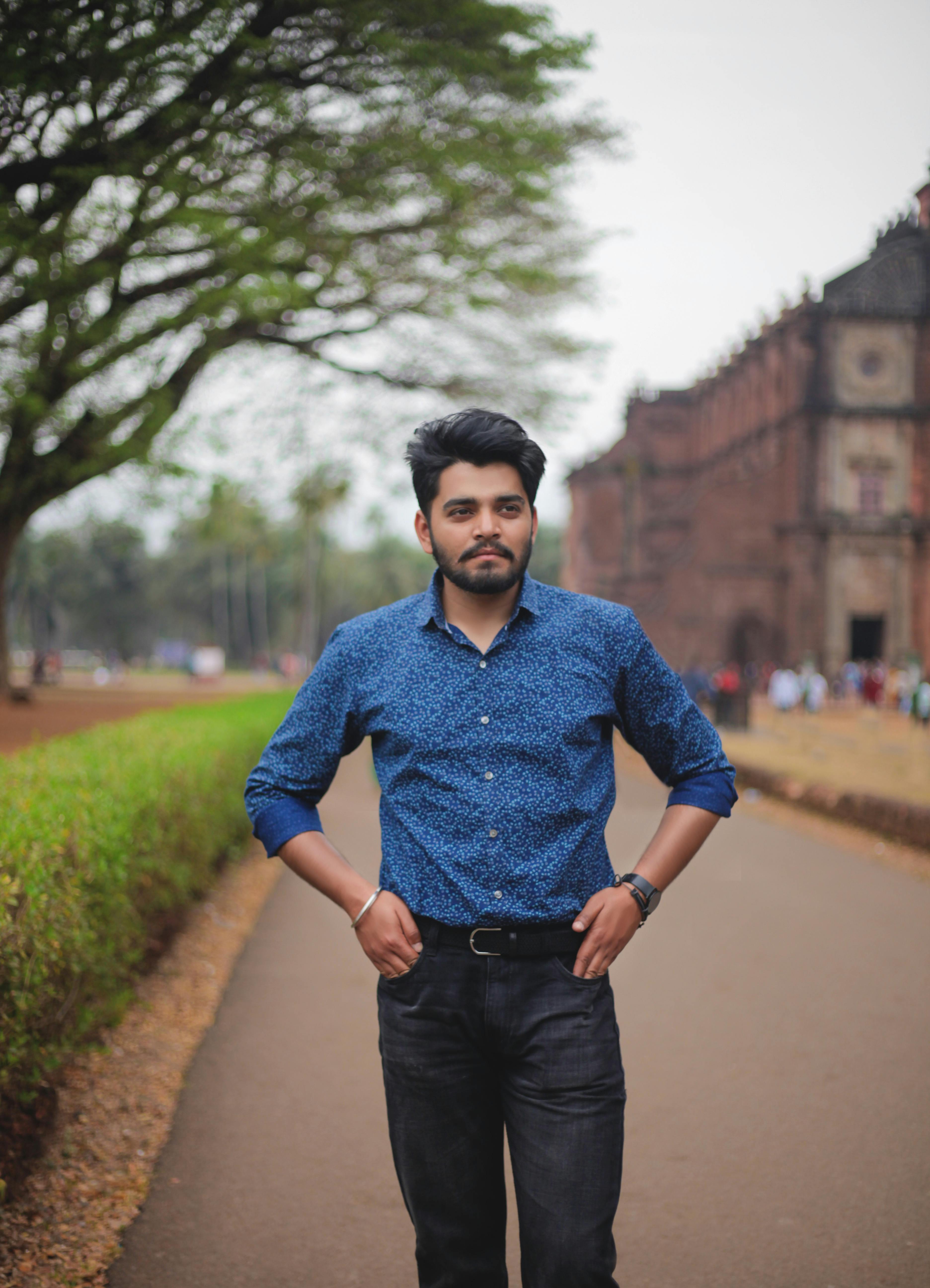 Stylish young man walking confidently outside in Bandoli, India.