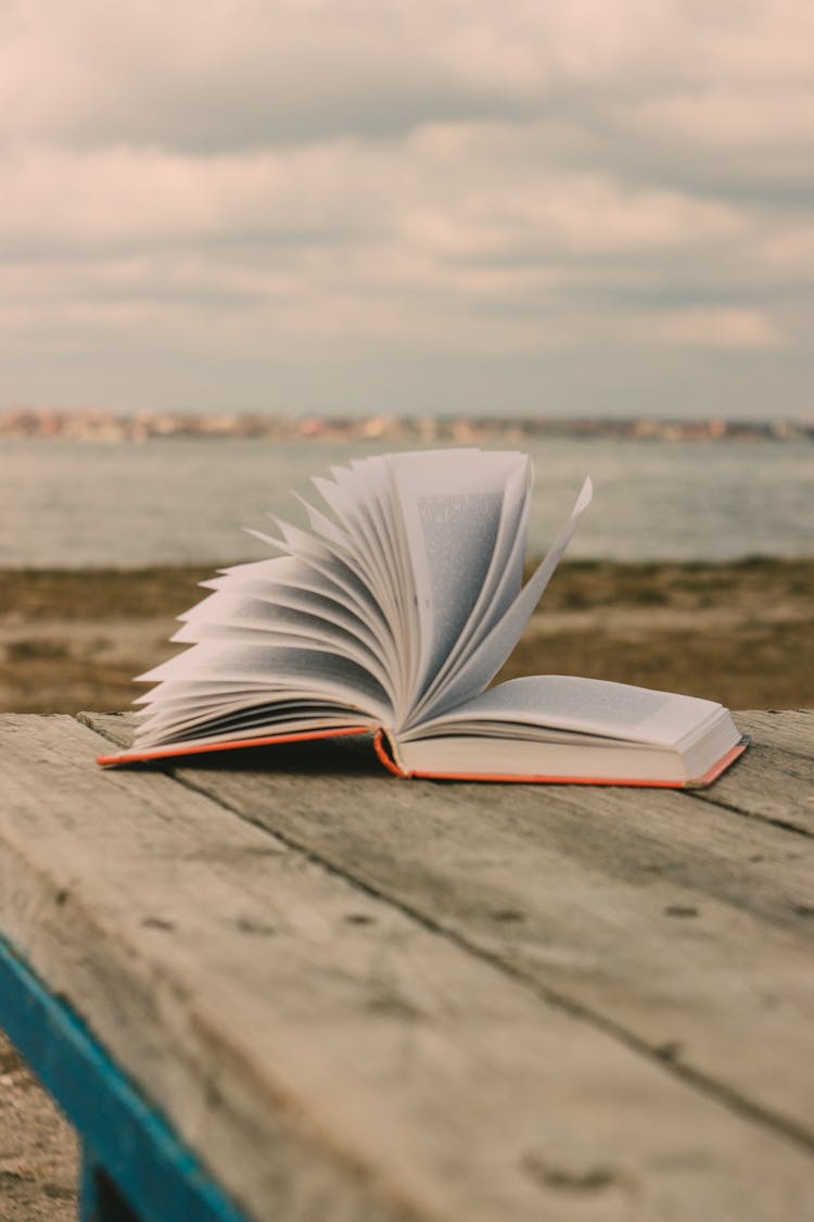 Open Book On Wooden Table