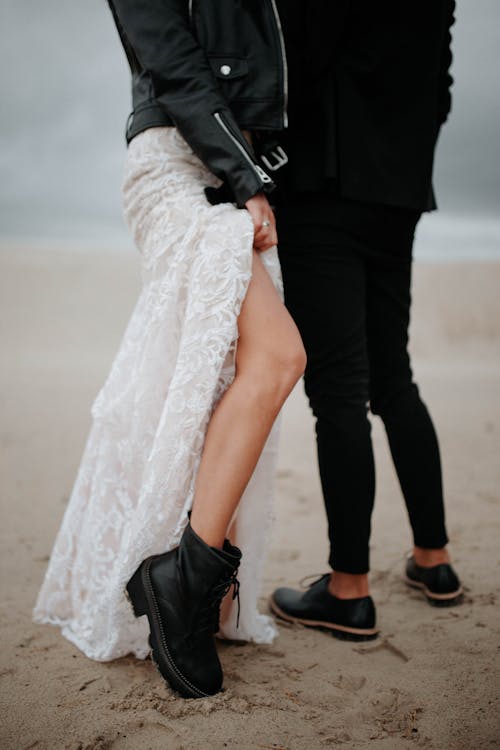 Bride in Boots and Leather Jacket and Groom on the Beach 
