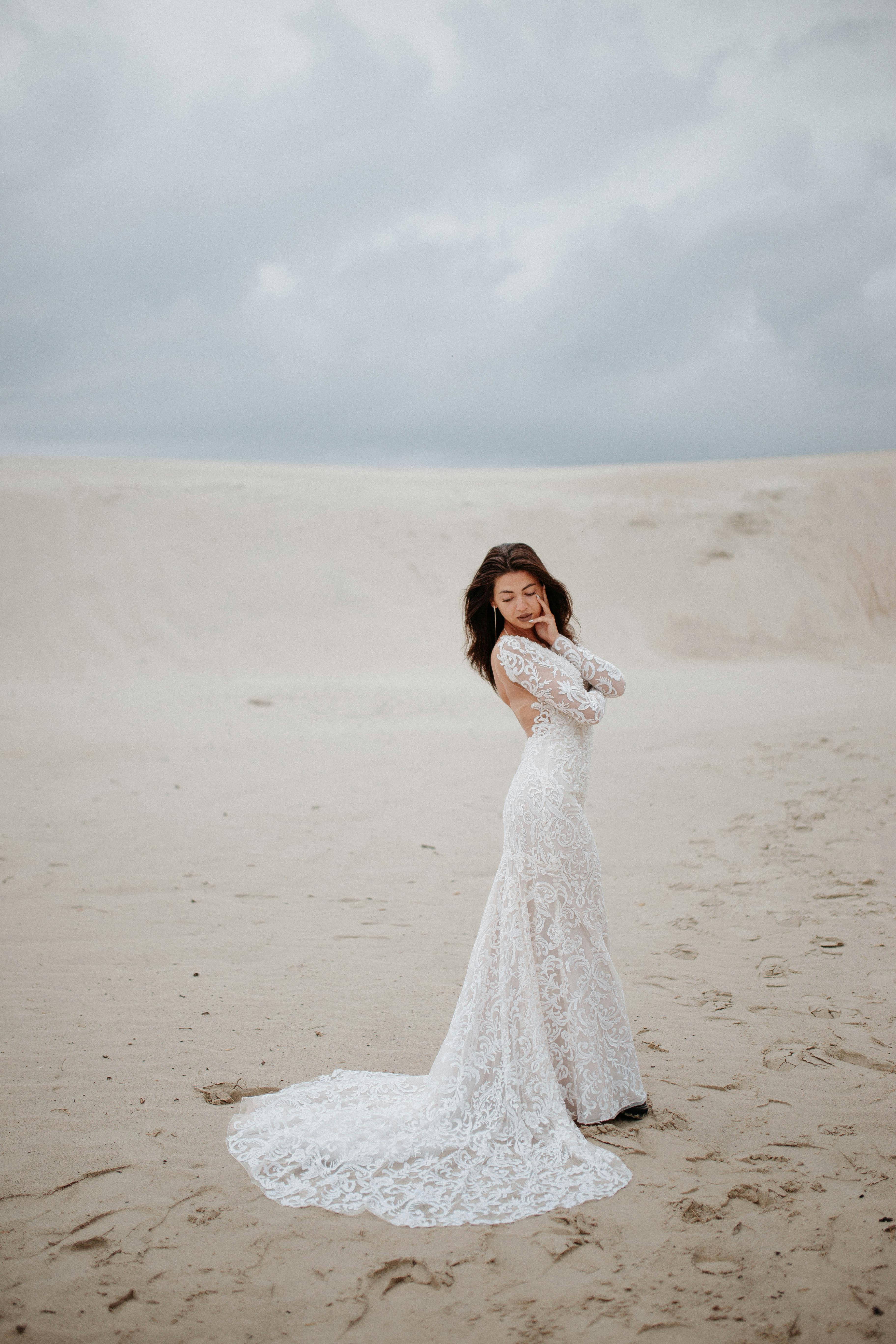 beautiful bride wearing wedding dress on desert