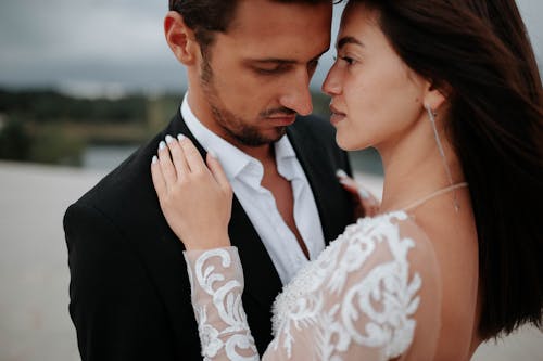 Bride and Groom Standing Close to Each Other on the Beach 