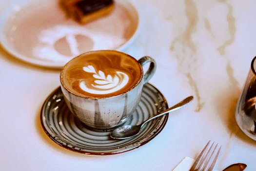 Close-up of a beautifully crafted latte art in a serene cafe ambiance, perfect for coffee lovers.