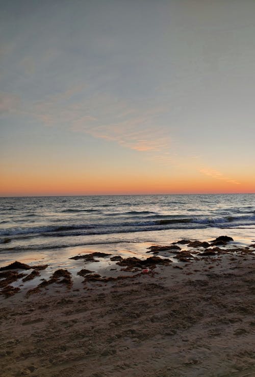 View of a Beach and Sea at Sunset