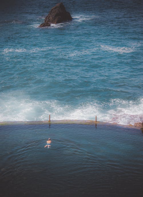 Aerial View of a Man Swimming in the Natural Swimming Pool, Los Gigantes, Tenerife, Spain