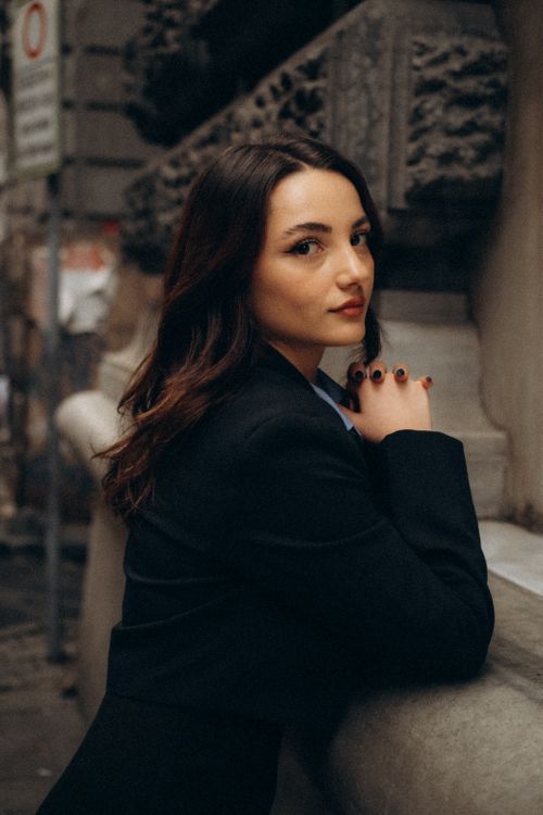 Free A young woman poses confidently on a historic street in Istanbul, Türkiye. Stock Photo