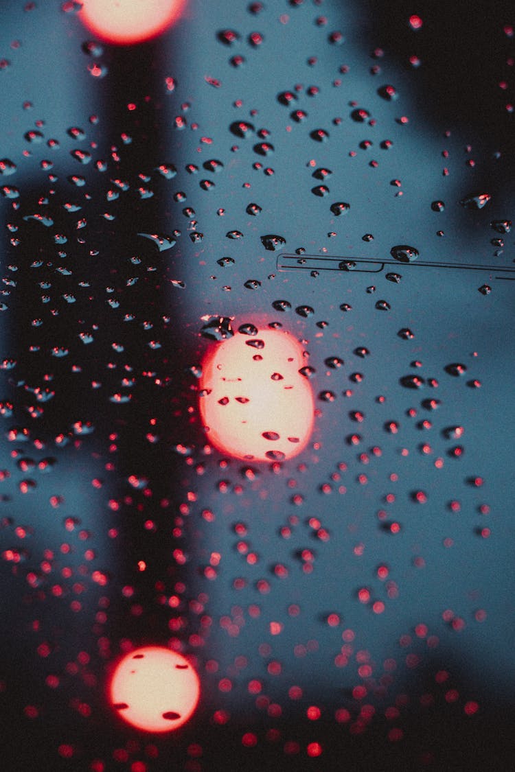 Blurred Lights Behind Wet Glass