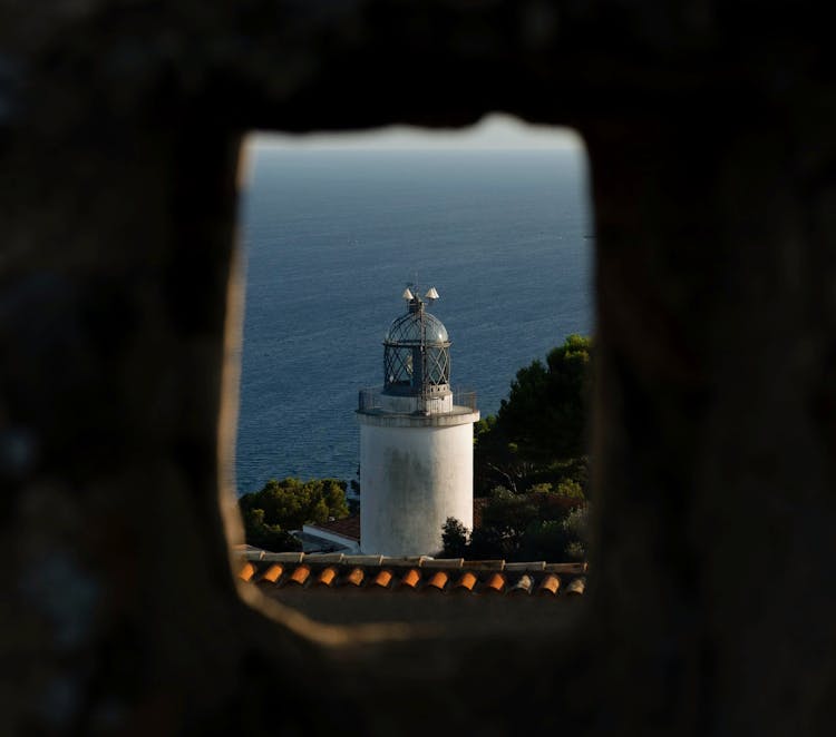 San Sebastian Lighthouse Seen Through A Hole In The Wall