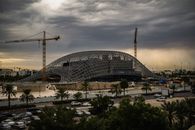 Innovative construction in Kuwait City under dramatic cloudy skies.