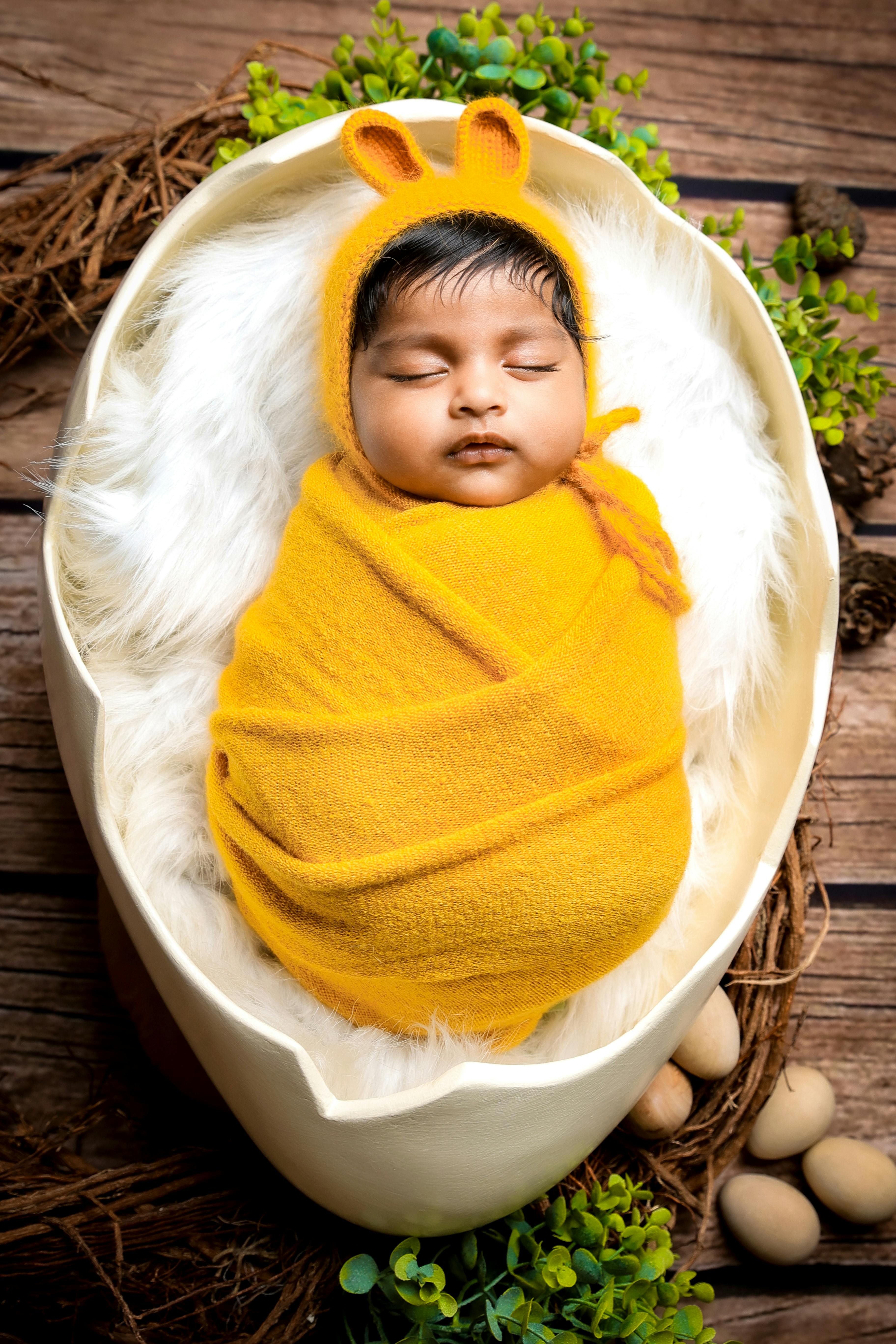 Newborn in Egg Shape Bed · Free Stock Photo