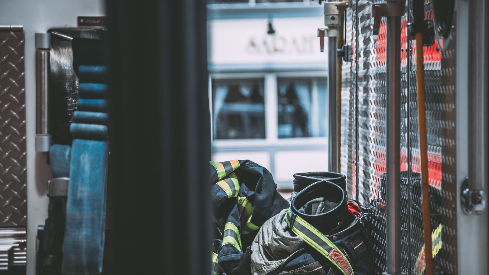 A detailed shot of firefighter gear inside a fire truck, emphasizing emergency readiness.