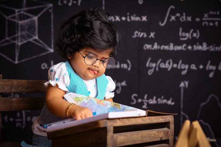 Portrait Of A Cute Toddler Dressed Up Like A Teacher