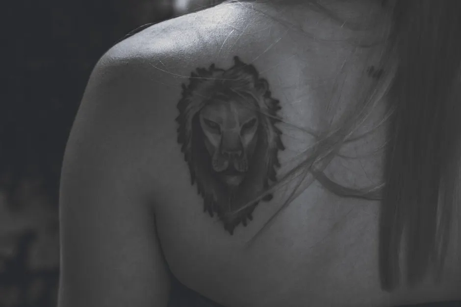 Black and white close-up of a detailed temporary tattoo on the shoulder blade