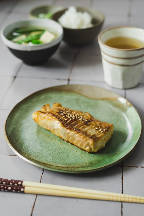 Japanese Food with Salmon on a Green Ceramic Plate