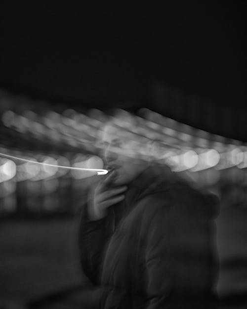 Reflection of Man Smoking in Glass