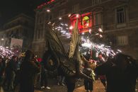 Exciting night scene of a cultural festival in Barcelona, featuring fireworks and performers.