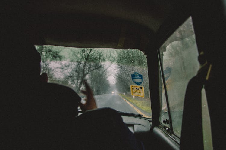 Man Driving Car In Rain