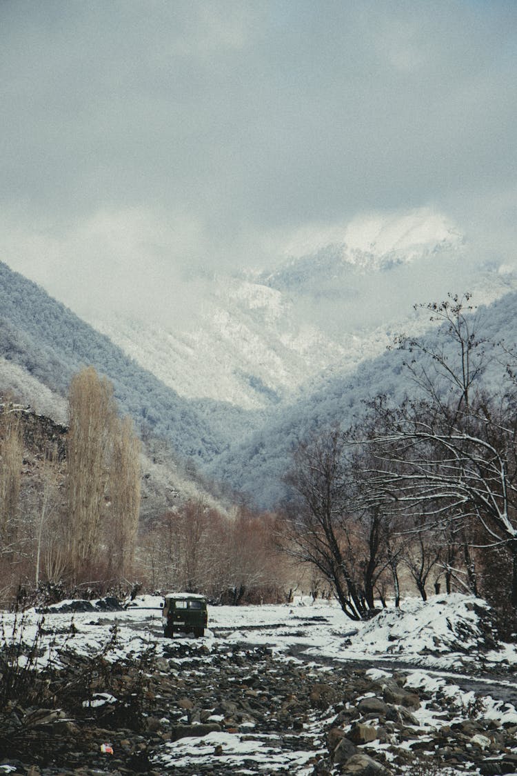 Truck Driving In Valley In Winter Mountains Landscape