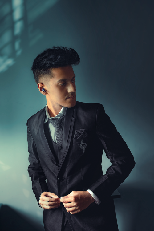 Free Stylish portrait of a young man in a suit exuding elegance and confidence. Stock Photo
