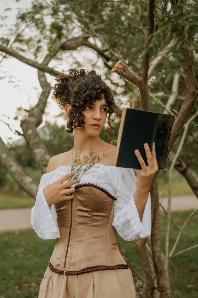 Woman Posing With A Book In A Hand