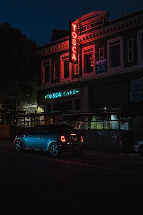 Free A car parked in front of a building at night Stock Photo