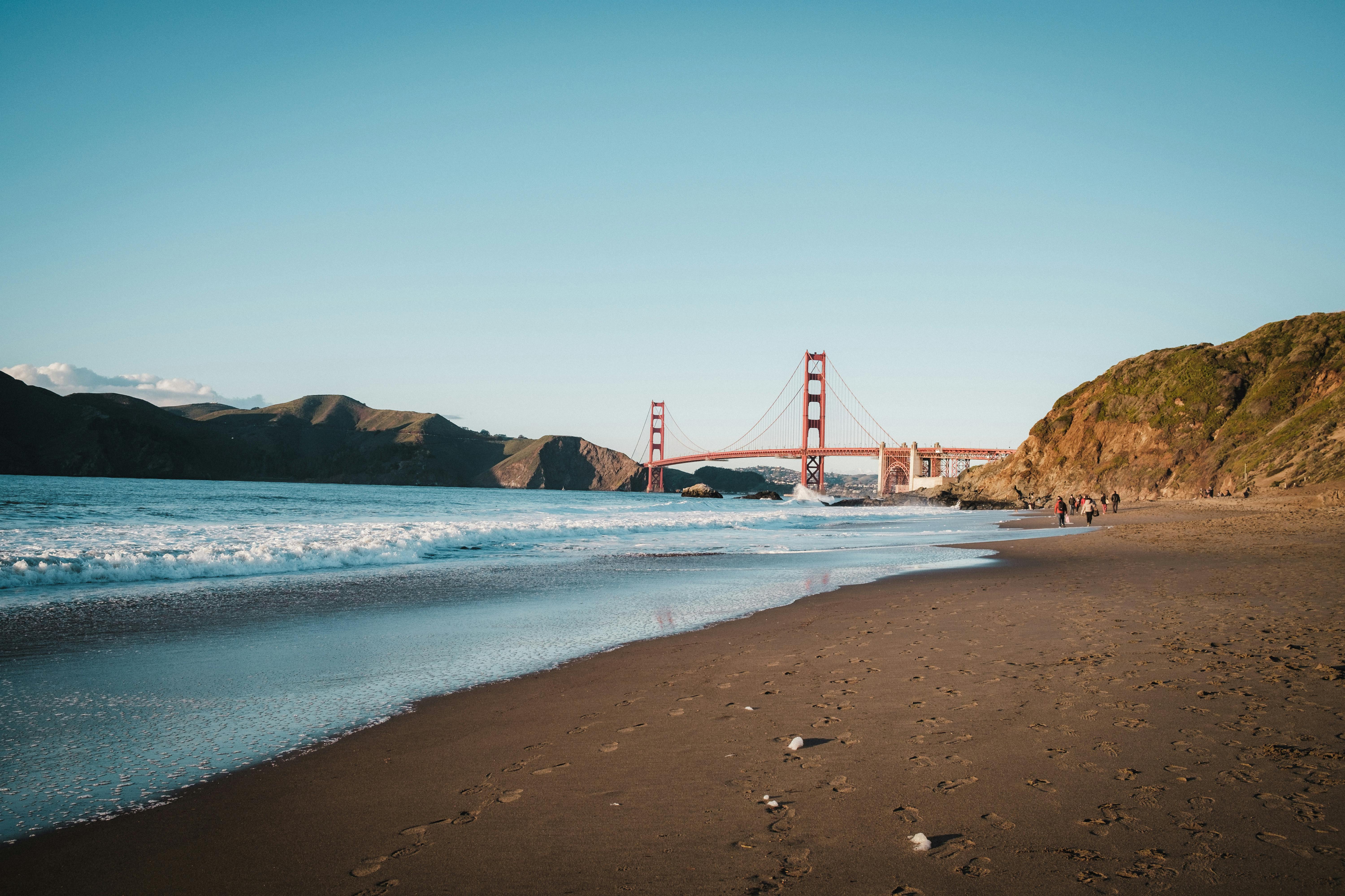 A beach with the golden gate bridge in the background