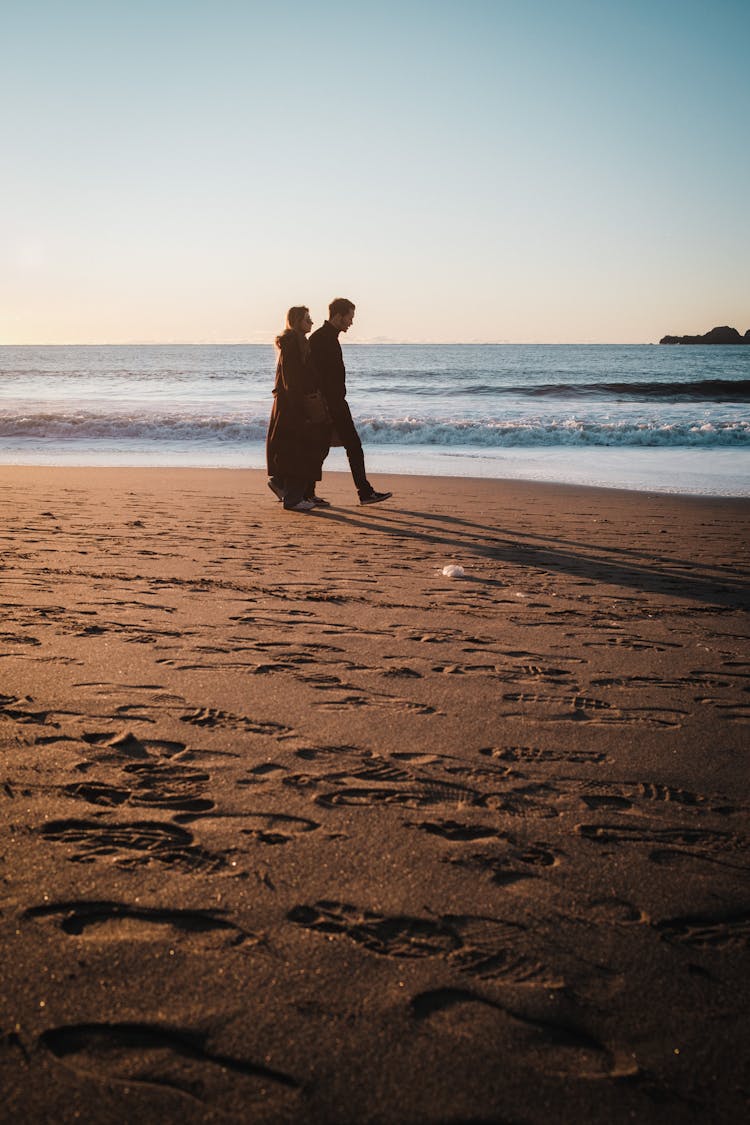 Couple Walking On Beach