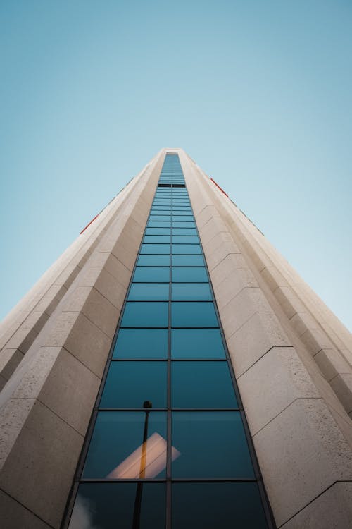 Low Angle Shot of a Skyscraper Facade under Blue Sky 