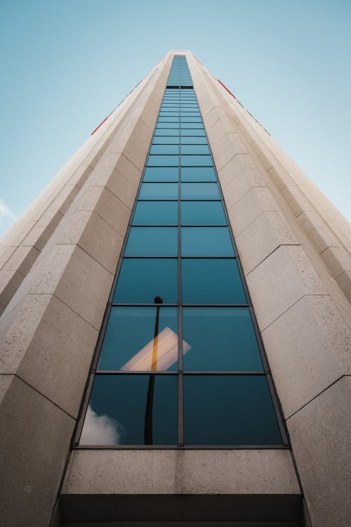 Low Angle Shot of a Skyscraper Facade under Blue Sky 